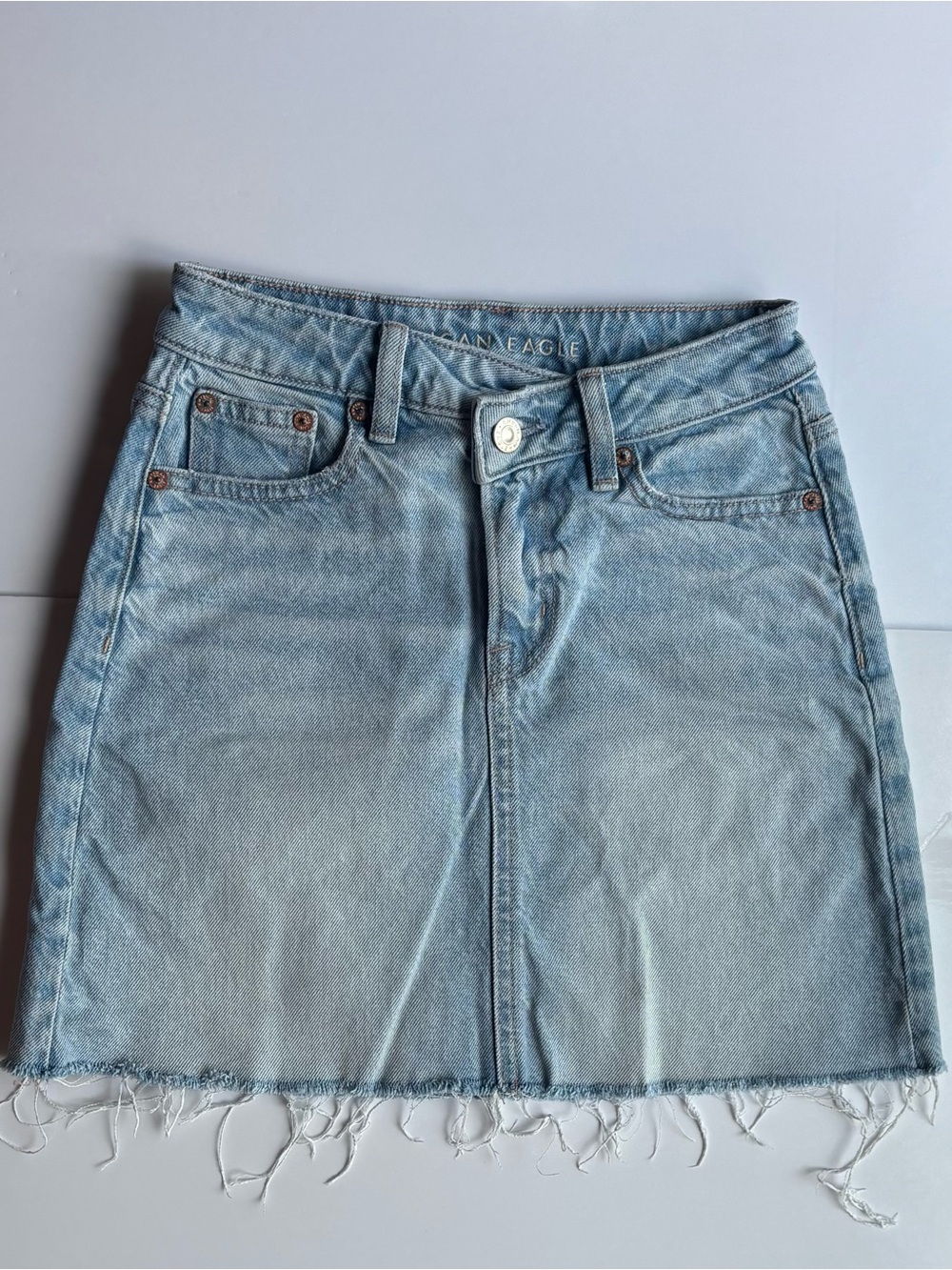 American eagle light wash denim jean mini skirt crossover waist frayed hem Y2K